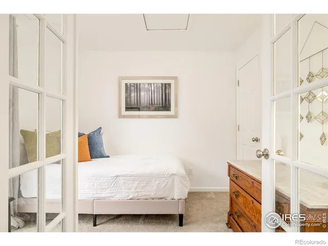 a bedroom with a bed and a painting on the wall