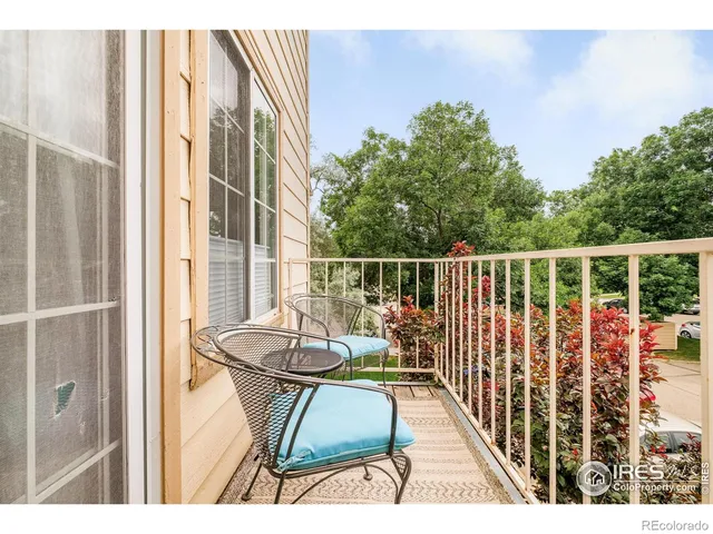 a balcony with table and chairs