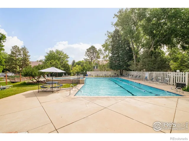 a view of a swimming pool with an outdoor space and seating area