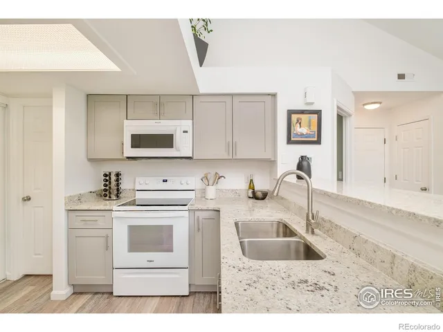 a kitchen with stainless steel appliances granite countertop a sink stove and cabinets