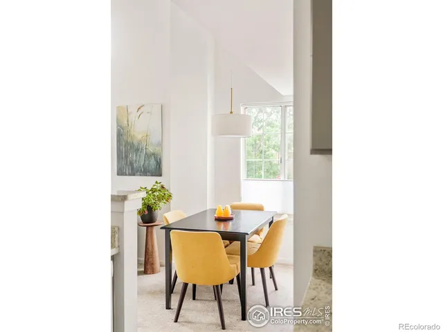 a view of a dining room with furniture and a potted plant