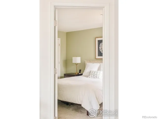 a bedroom with a bed and a mirror