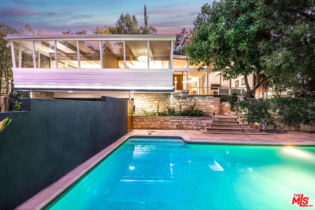 a view of yard with swimming pool and table and chairs