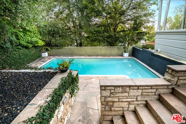 a view of a tennis ground with large trees