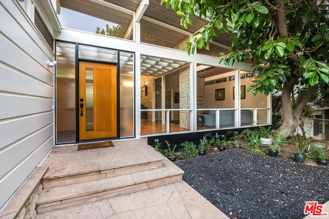 a front view of a house with a garden