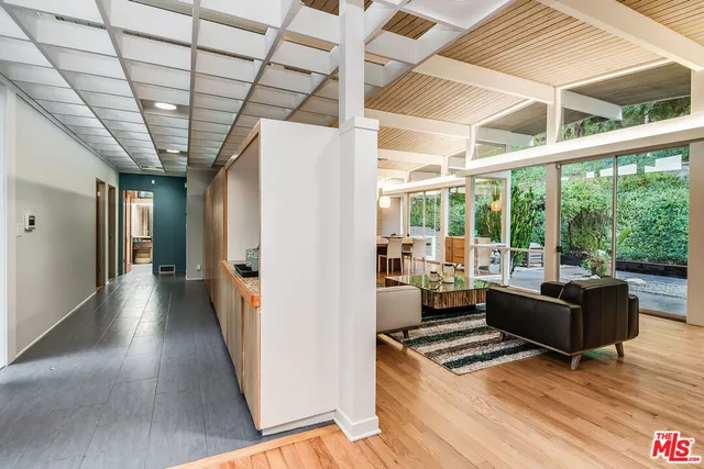 a living room with furniture and a floor to ceiling window