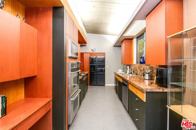 a kitchen with stainless steel appliances granite countertop a stove and a refrigerator