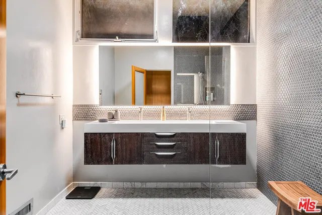 a bathroom with a sink and a mirror