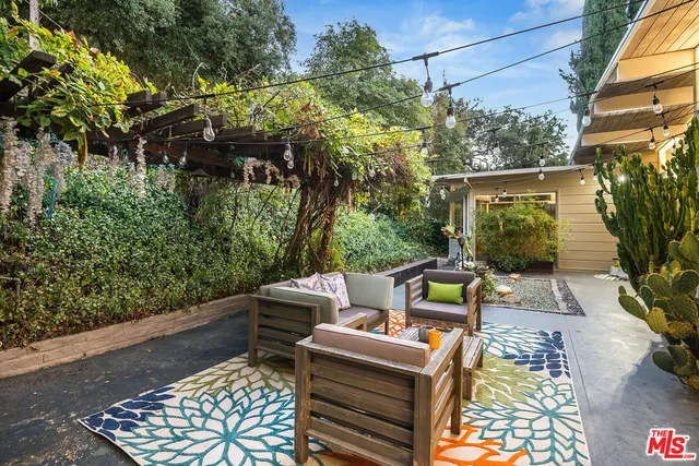a view of a chairs and table on the balcony
