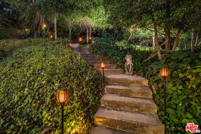 a view of a house with backyard and sitting area