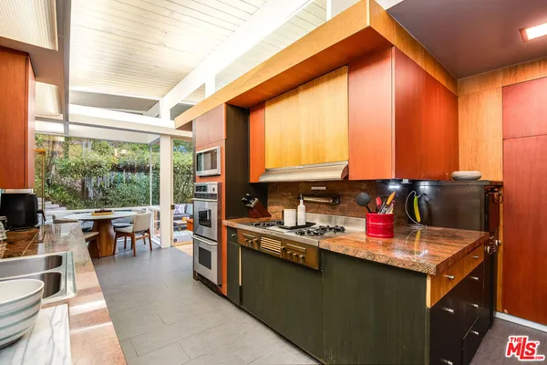 a kitchen with a large window and dining table