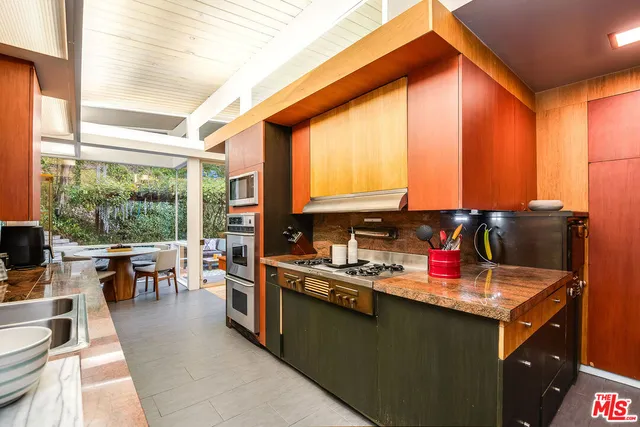a kitchen with a large window and dining table