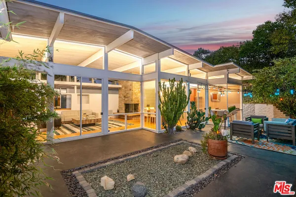 a view of a living room and floor to ceiling window and wooden floor