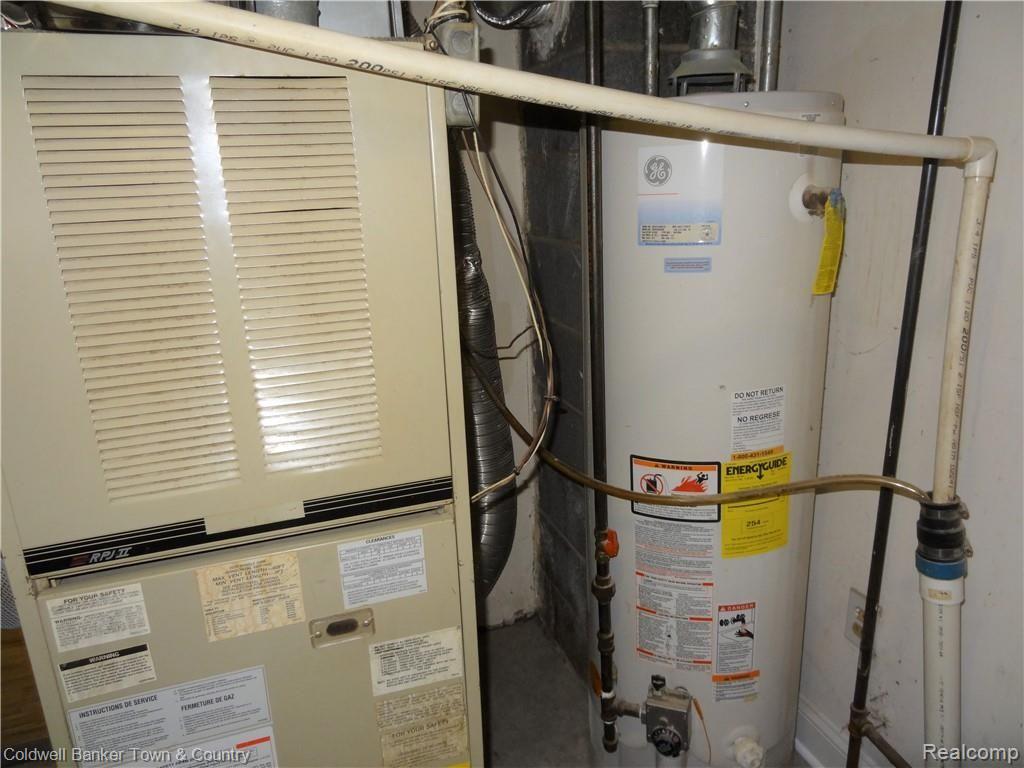 223 Ruppert Street Commerce Township, MI 48382 - Photo 25 of 31 Furnace and hot water heater in utility/laundry room.