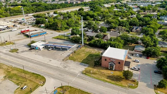 an aerial view of a house with swimming pool and sitting area