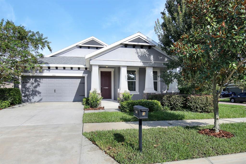a front view of a house with a yard and garage