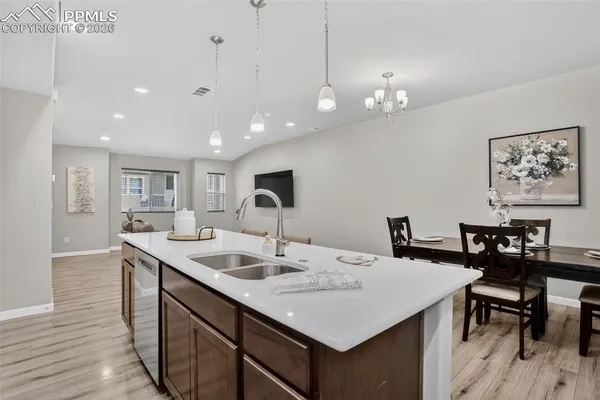 a view of a kitchen area with furniture and wooden floor