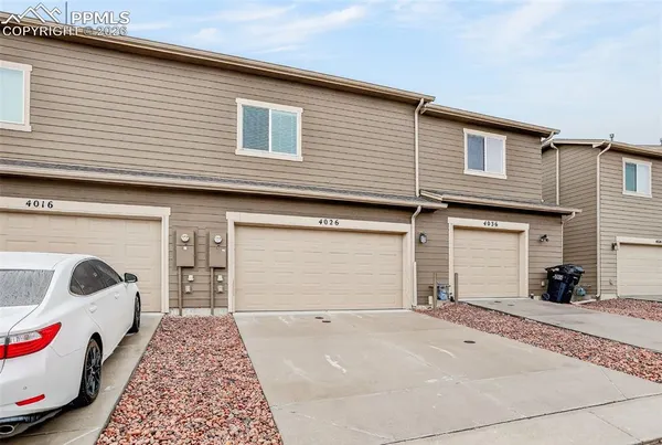 a front view of a house with parking space