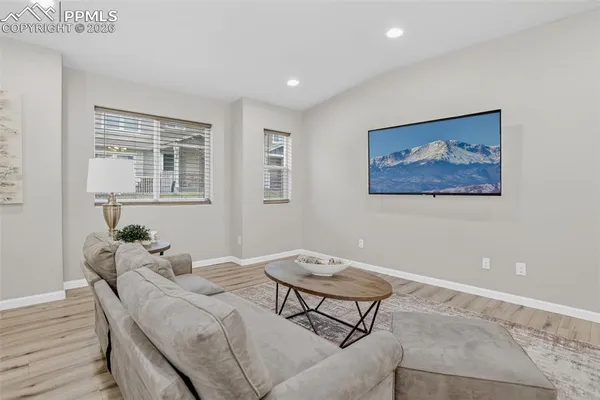 a living room with furniture and wooden floor