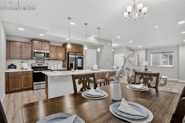 a large kitchen with a table and chairs in it