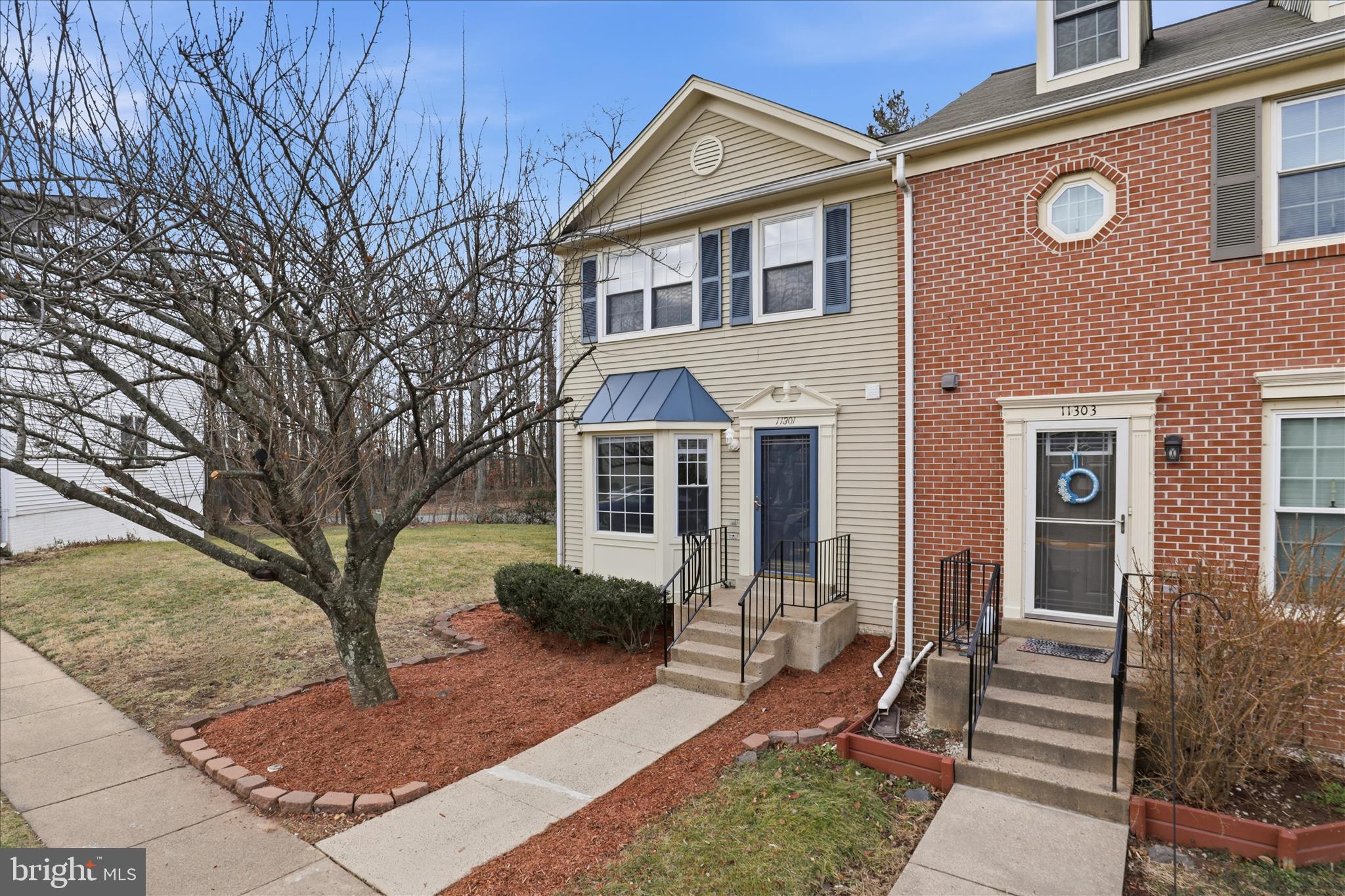 11301 Kessler Place Manassas, VA 20109 - Photo 1 of 52 a front view of a house with garden