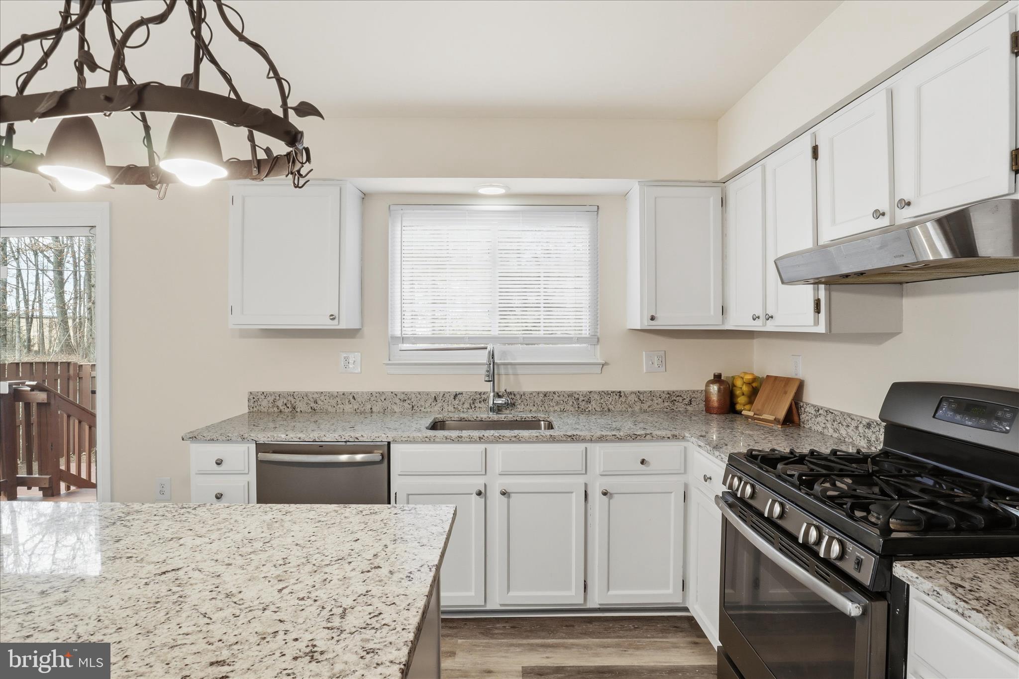 11301 Kessler Place Manassas, VA 20109 - Photo 18 of 52 a kitchen with stainless steel appliances granite countertop a sink stove and cabinets