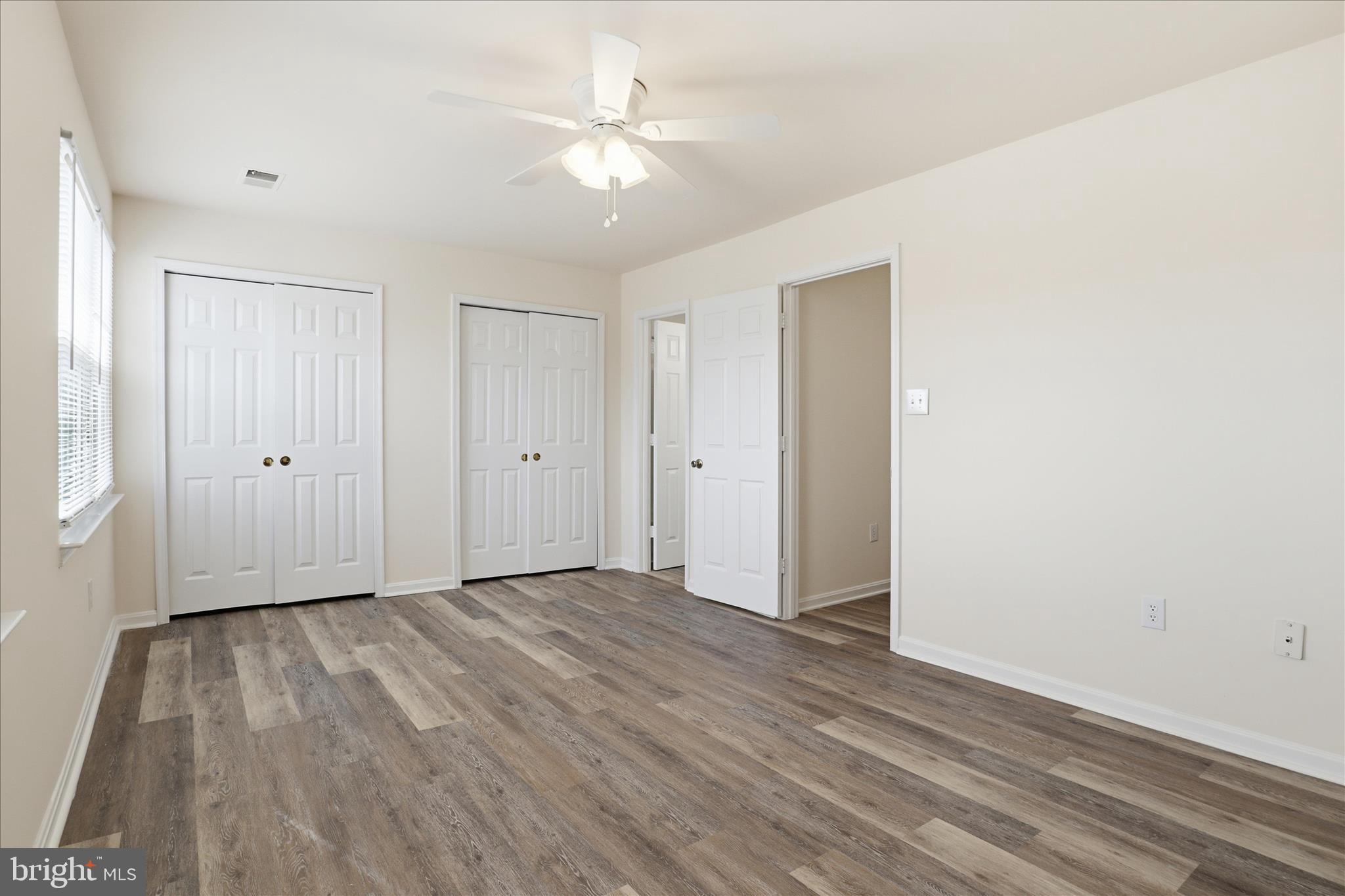 11301 Kessler Place Manassas, VA 20109 - Photo 23 of 52 an empty room with wooden floor and ceiling fan
