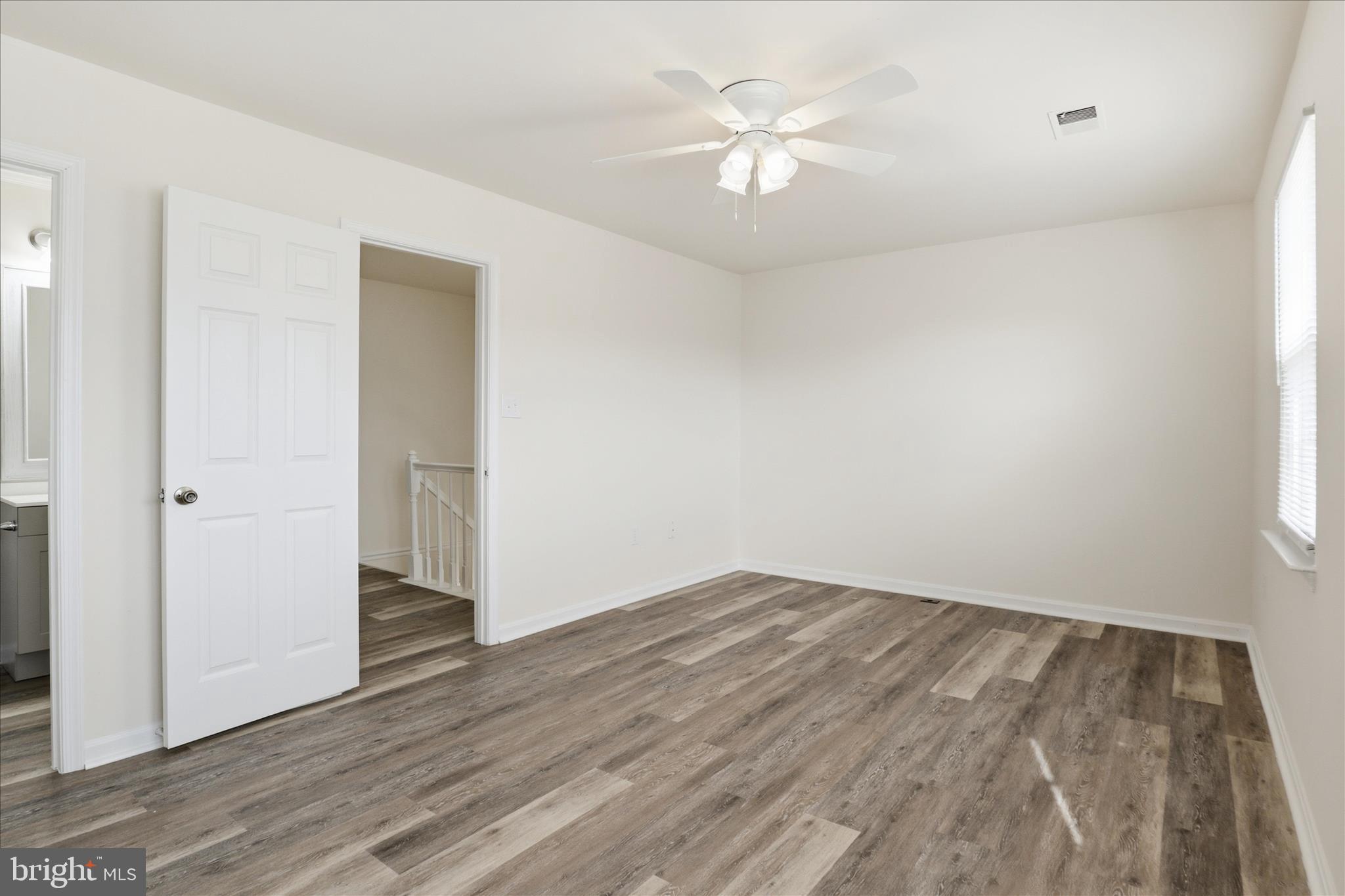 11301 Kessler Place Manassas, VA 20109 - Photo 24 of 52 an empty room with wooden floor and ceiling fan