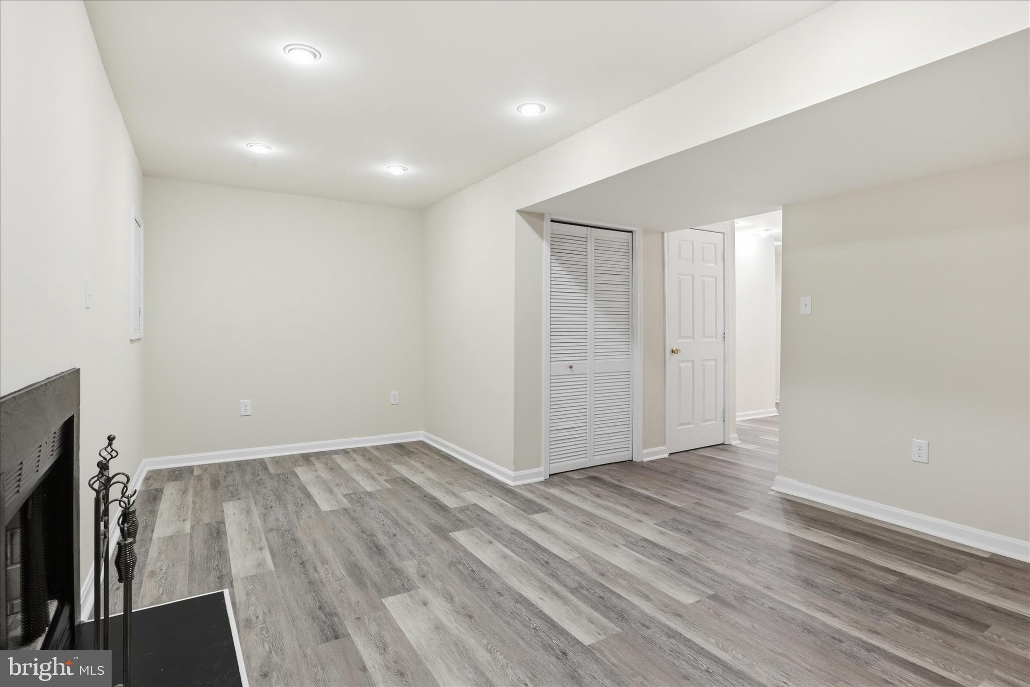 11301 Kessler Place Manassas, VA 20109 - Photo 35 of 52 an empty room with wooden floor and a fireplace