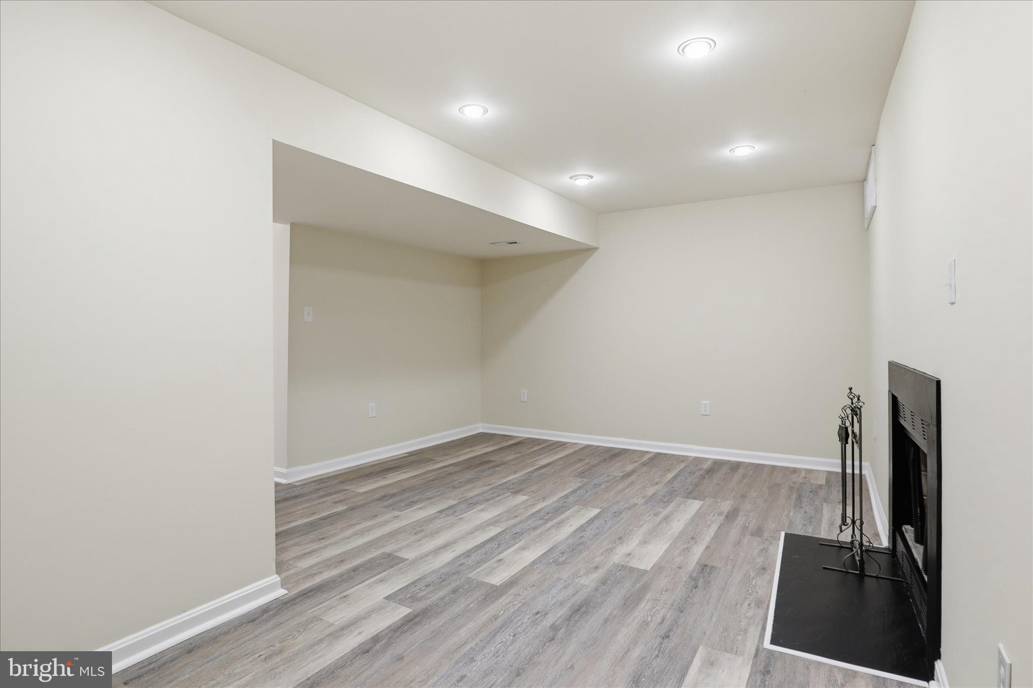 11301 Kessler Place Manassas, VA 20109 - Photo 36 of 52 an empty room with wooden floor and a fireplace