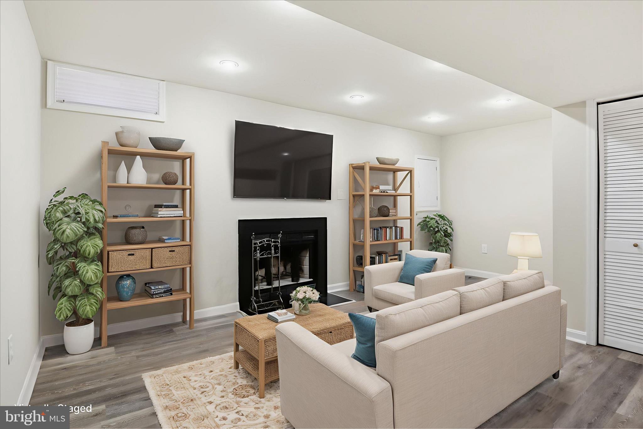 11301 Kessler Place Manassas, VA 20109 - Photo 38 of 52 a living room with furniture a fireplace and a flat screen tv