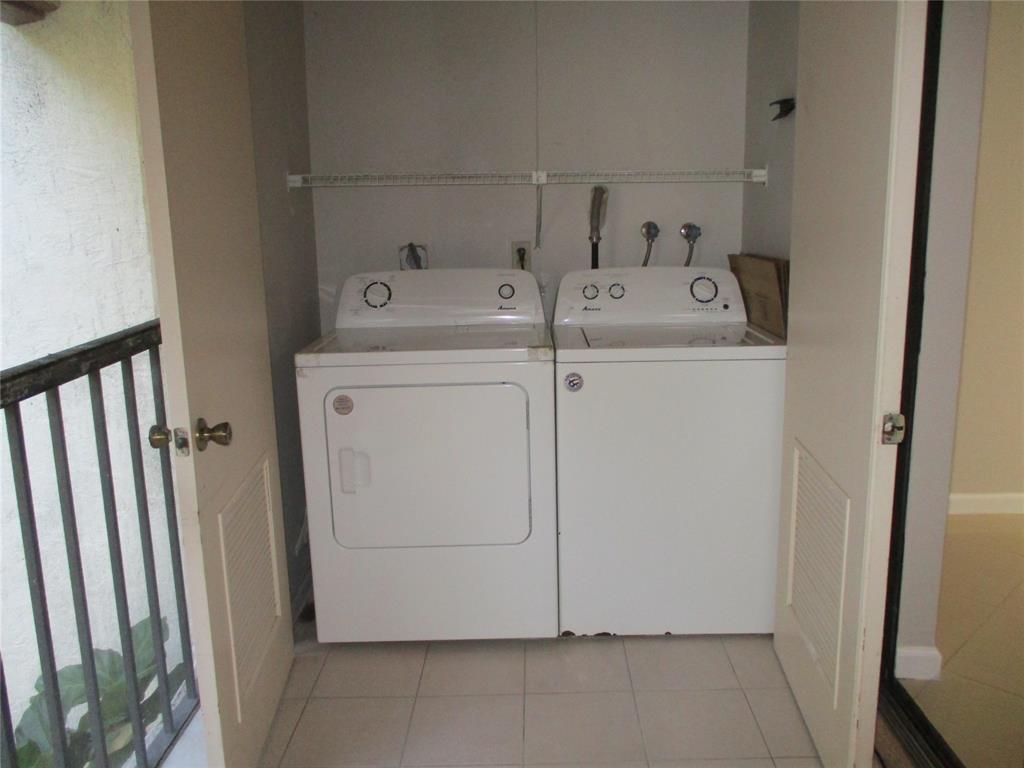 22052 Palms Way, Unit 205 Boca Raton, FL 33433 - Photo 13 of 28 a utility room with dryer and washer