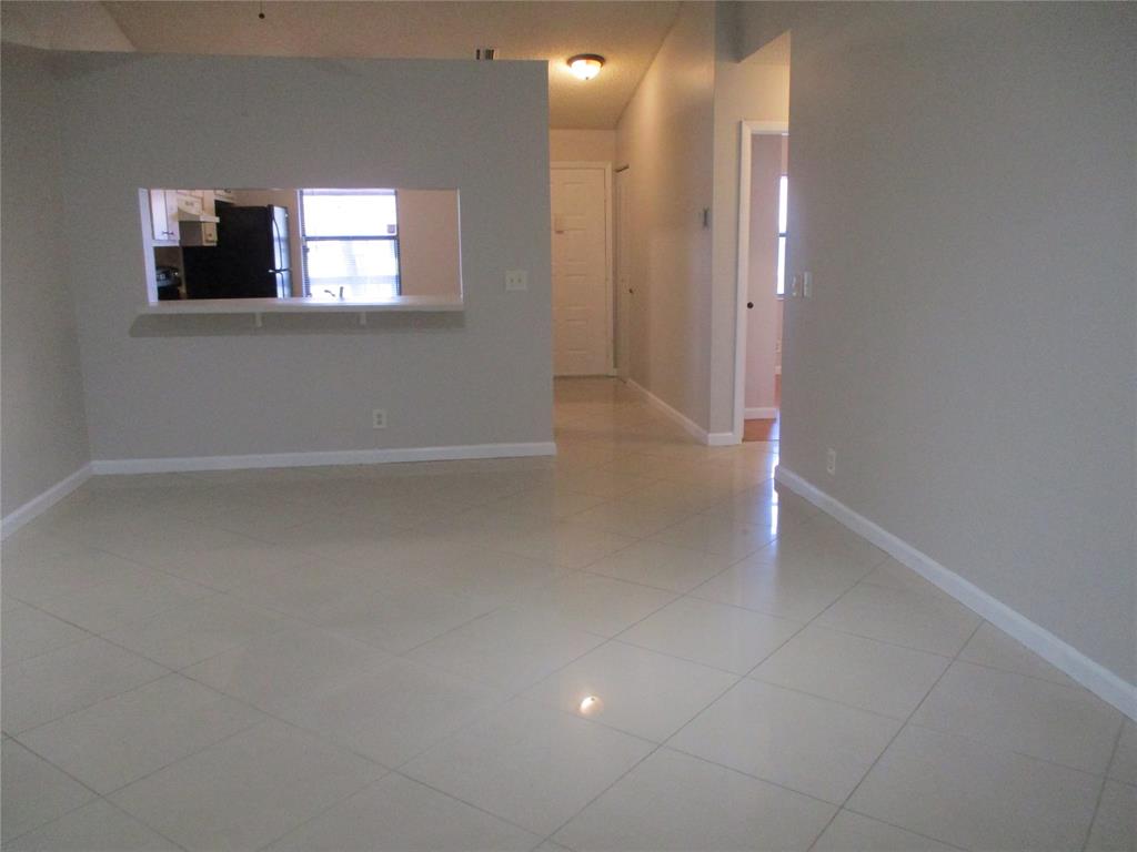 22052 Palms Way, Unit 205 Boca Raton, FL 33433 - Photo 14 of 28 an empty room with windows and fireplace