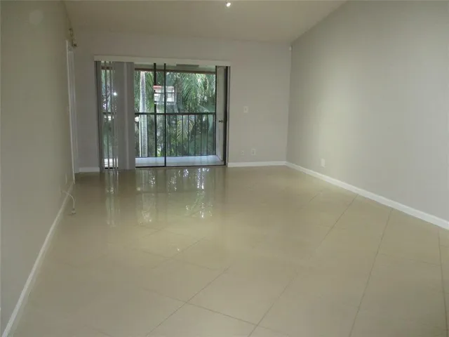 an empty room with large windows and door