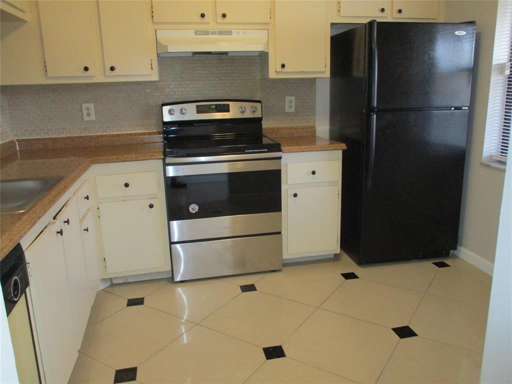 22052 Palms Way, Unit 205 Boca Raton, FL 33433 - Photo 3 of 28 a kitchen with appliances and cabinets