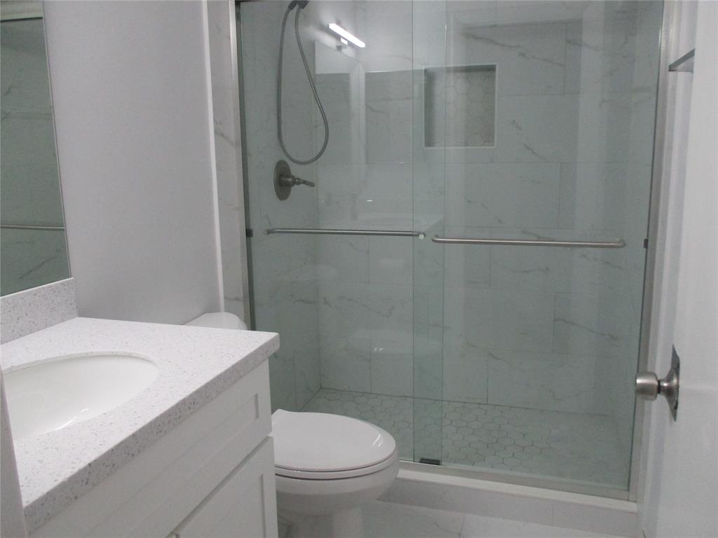 22052 Palms Way, Unit 205 Boca Raton, FL 33433 - Photo 9 of 28 a bathroom with a shower a toilet and sink