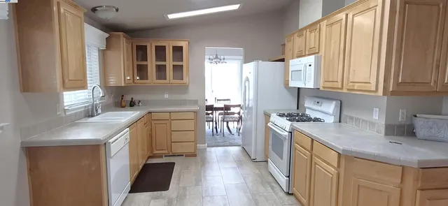 a kitchen with a sink stove top oven and cabinets