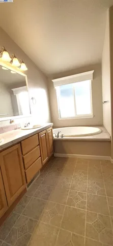 a bathroom with a sink vanity and a mirror