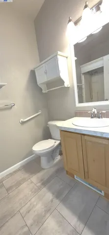a bathroom with a toilet a sink and mirror