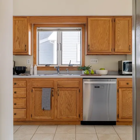 a kitchen with stainless steel appliances granite countertop a refrigerator and cabinets