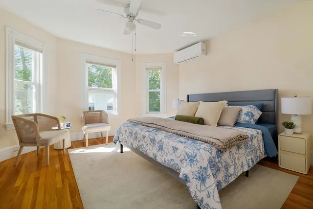 a bedroom with bed and a lounge chair