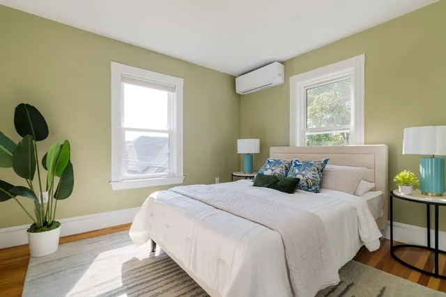 a bedroom with double bed and a window