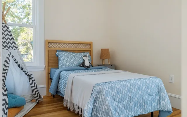 a bedroom with a bed and a window