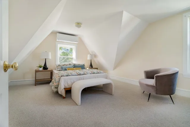 a bedroom with bed and window