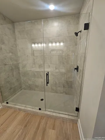 a bathroom with a glass shower door