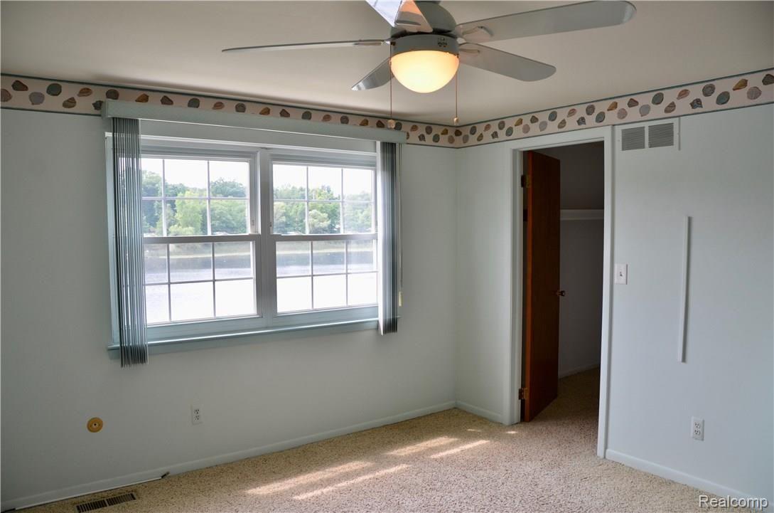 6681 Andersonville Road, Unit 28 Clarkston, MI 48346 - Photo 12 of 22 Bedroom with view of lake andspacious walk-in closet, ceiling fan