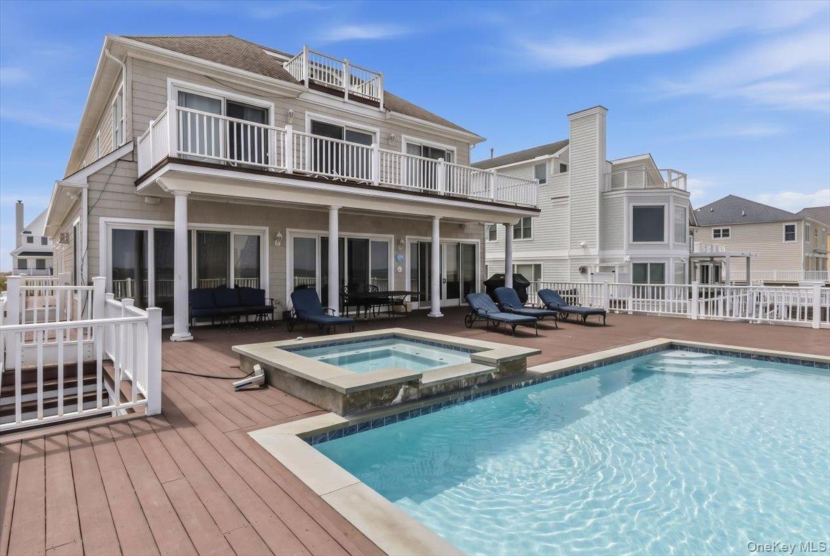 672 Dune Road Westhampton Beach, NY 11978 - Photo 1 of 38 a view of a house with pool and sitting area