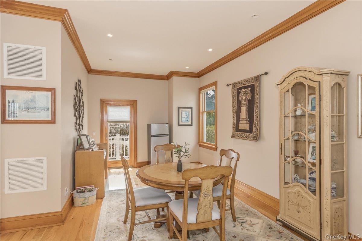 672 Dune Road Westhampton Beach, NY 11978 - Photo 15 of 38 a view of a dining room with furniture and wooden floor