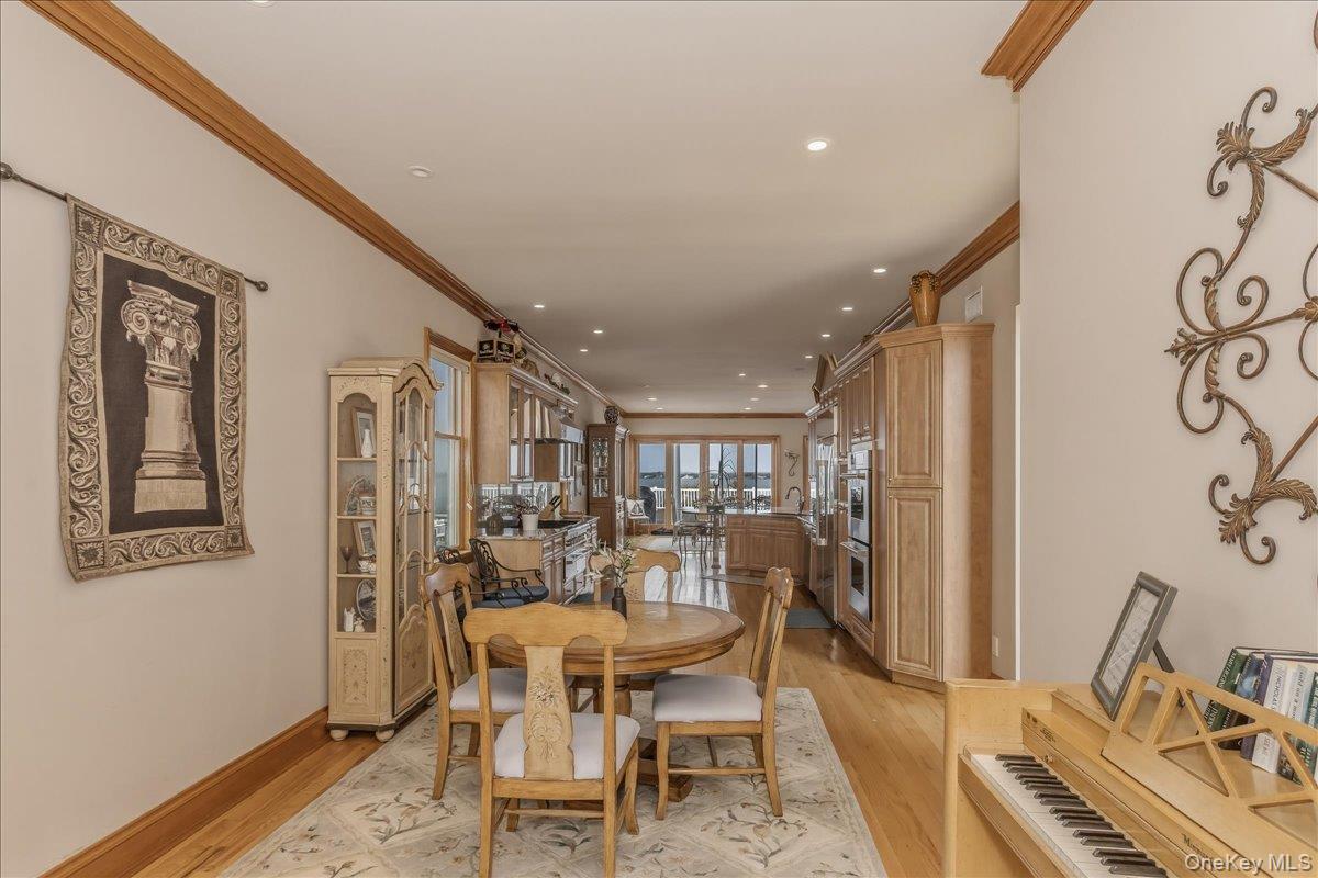 672 Dune Road Westhampton Beach, NY 11978 - Photo 16 of 38 a view of a dining room with furniture window and wooden floor
