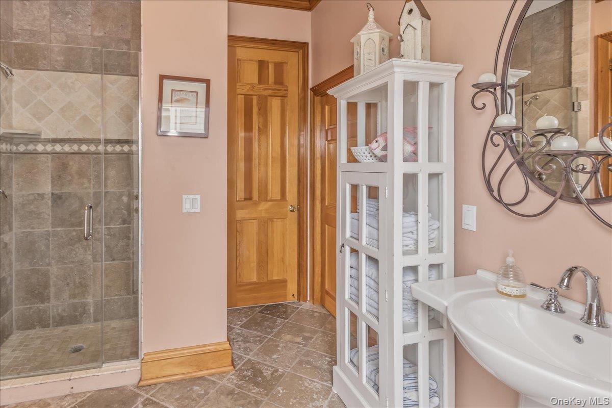 672 Dune Road Westhampton Beach, NY 11978 - Photo 20 of 38 a bathroom with a sink and a mirror